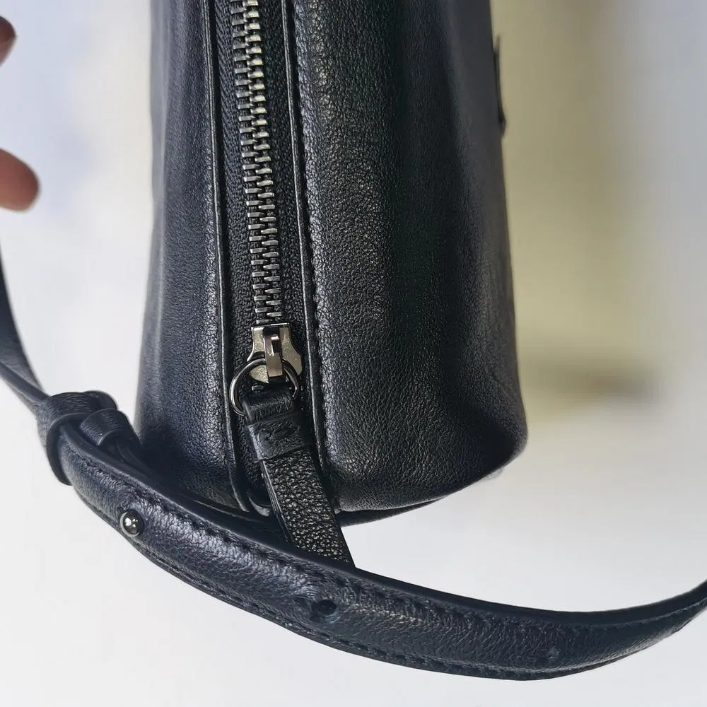 Sleek Black Cylindrical Shoulder Bag with Adjustable Strap