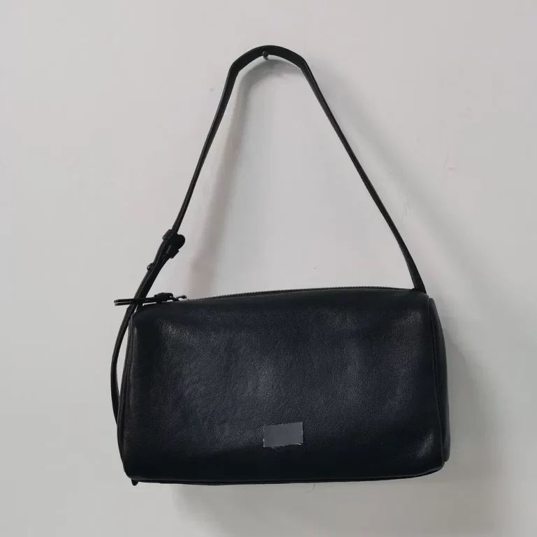 Sleek Black Cylindrical Shoulder Bag with Adjustable Strap