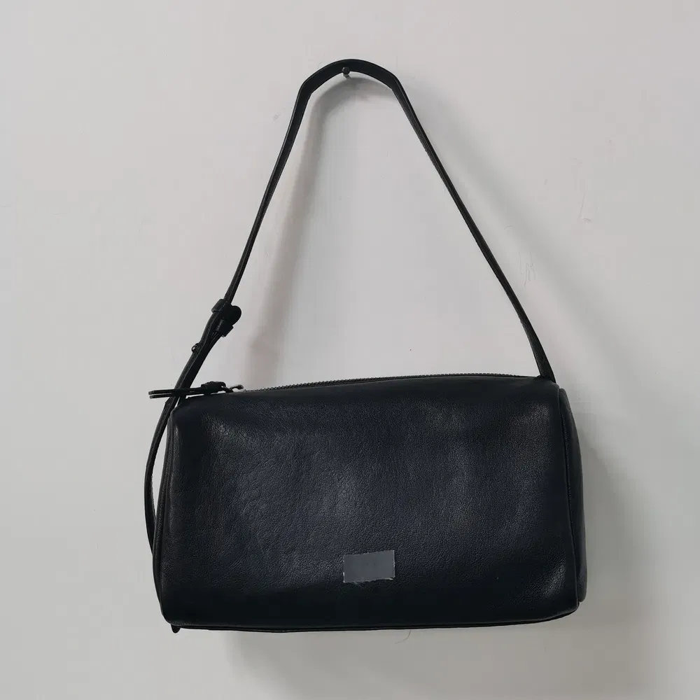 Sleek Black Cylindrical Shoulder Bag with Adjustable Strap